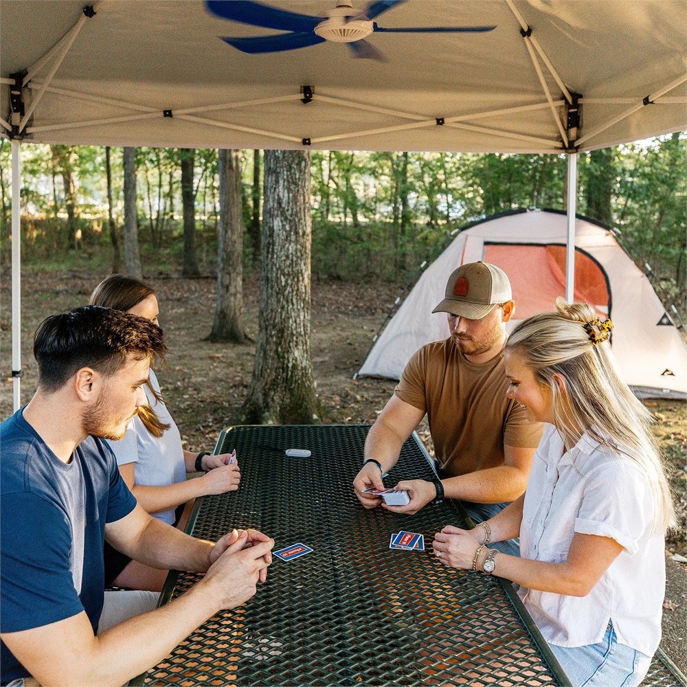 Manufacturer camping scene showing a colored-blade canopy fan over a table