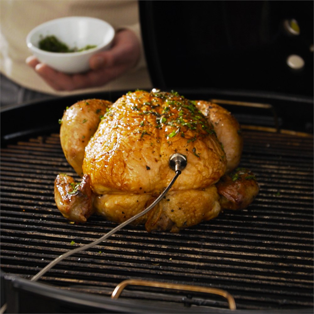 Food probe monitoring a whole chicken on the grill