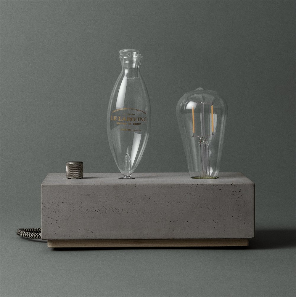 Concrete fragrance diffuser with clear glass vessel, control knob and Edison bulb