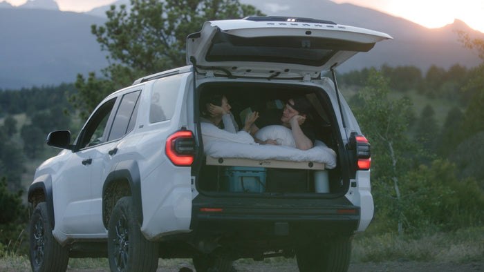 Hele cooler stored beneath a sleeping platform inside an SUV