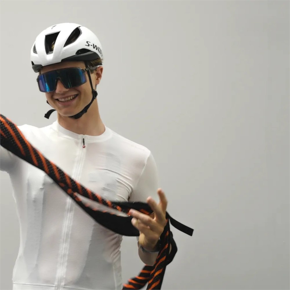Cyclist holding the removable black and orange airbag system