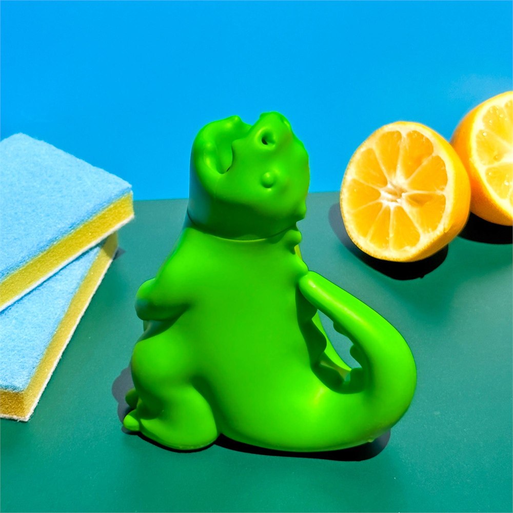 Dragon cleaner on a colorful surface beside sponges