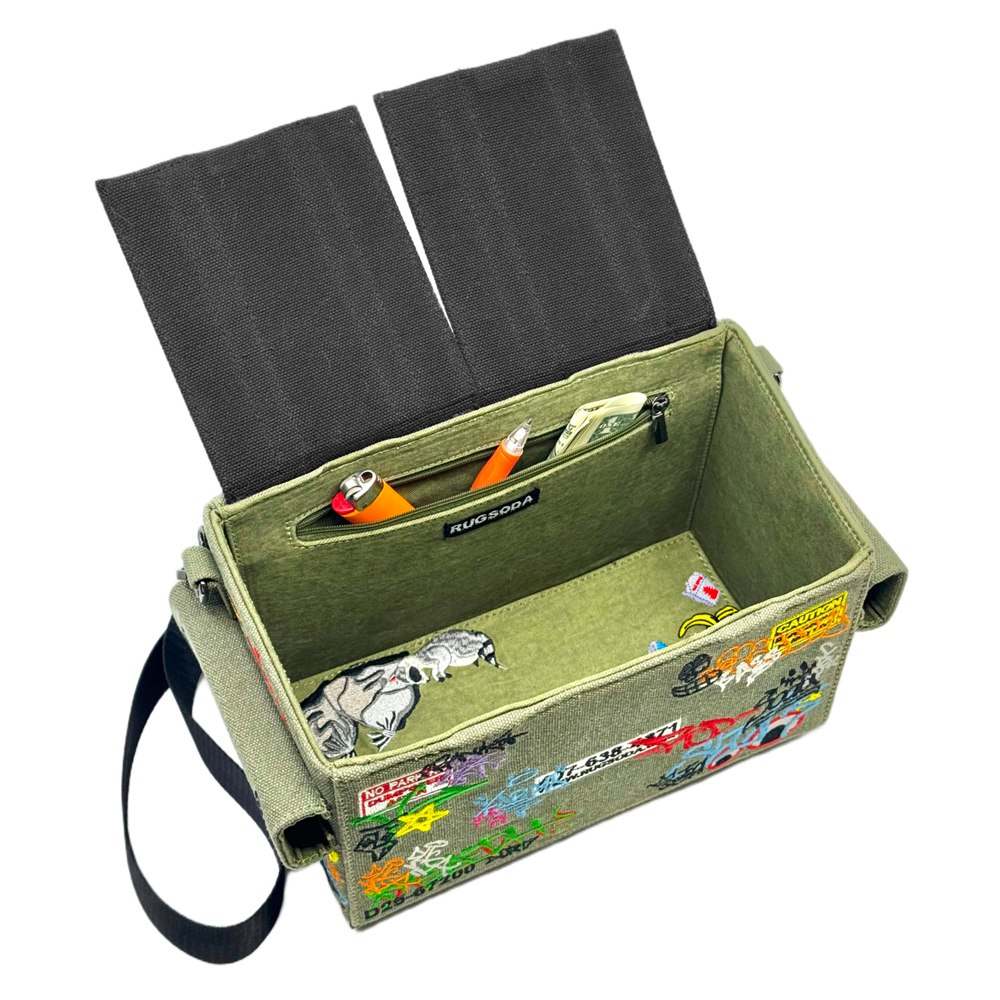 Open bag showing embroidered raccoon and interior zippered pocket