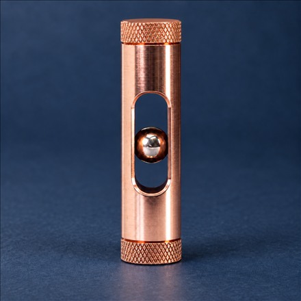 This Copper Desk Toy Makes a Magnetic Ball Fall in Slow Motion