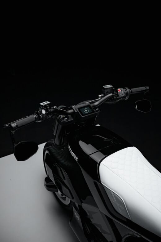White quilted seat and handlebar controls viewed from behind