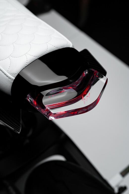 Translucent rear light below the white quilted seat