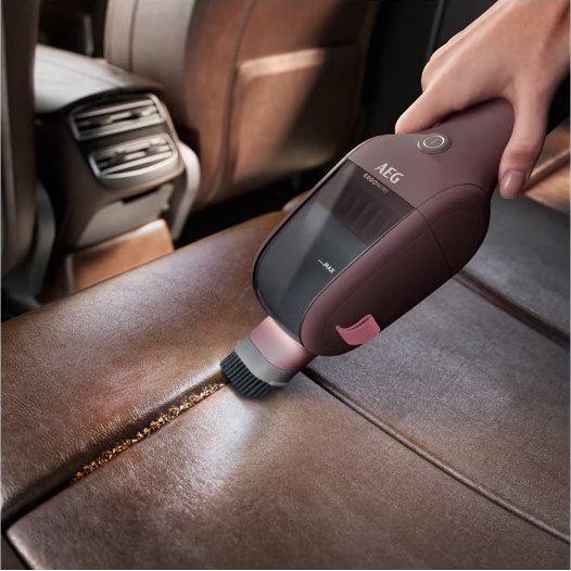 ErgoMini dusting brush cleaning a car seat seam