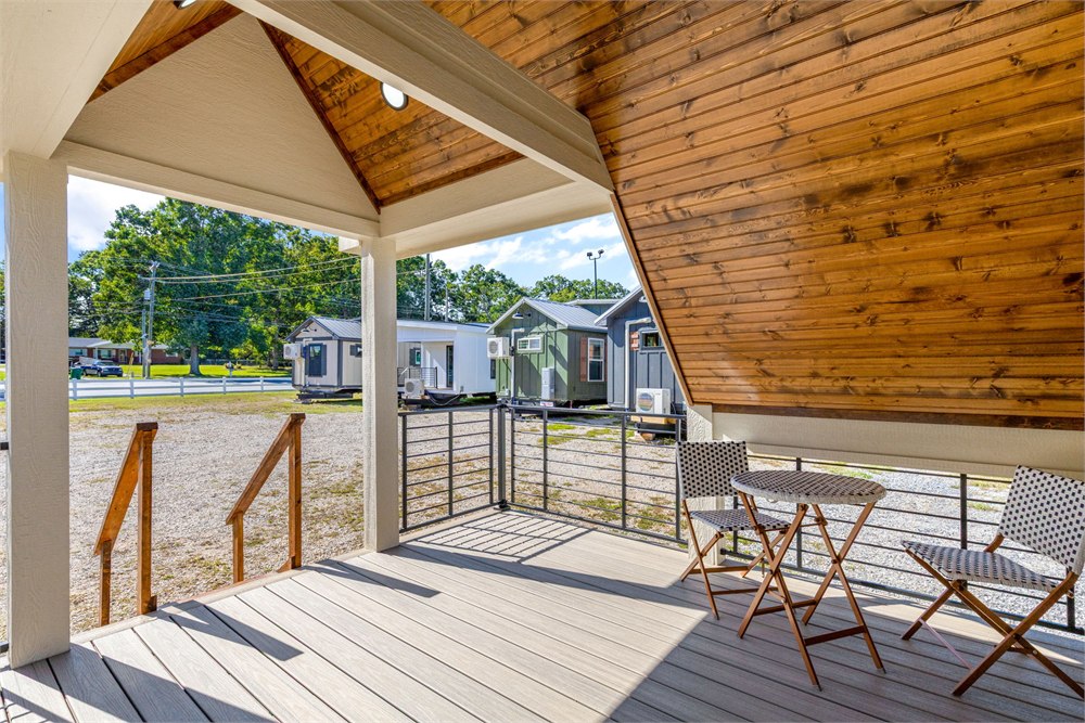 Covered Tinde porch with timber ceiling and black railings