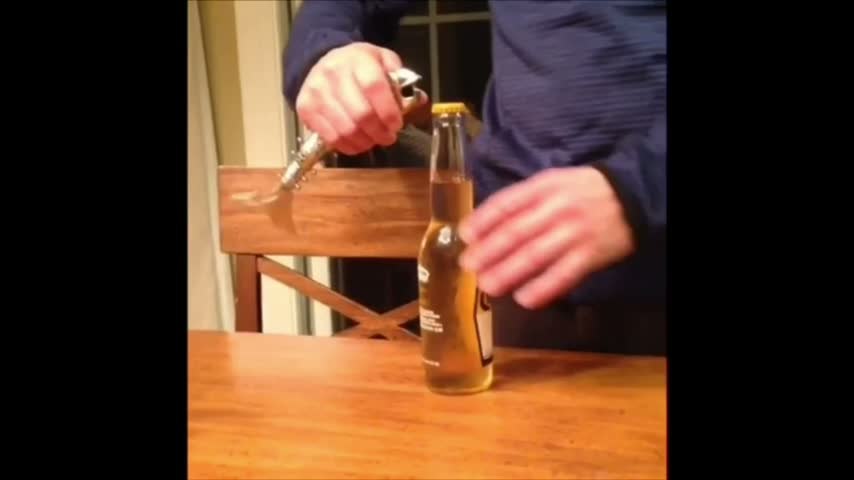 Still from Evvy demonstration showing the opener held beside a bottle