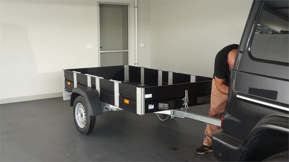 FALTOS trailer beside a vehicle in a garage