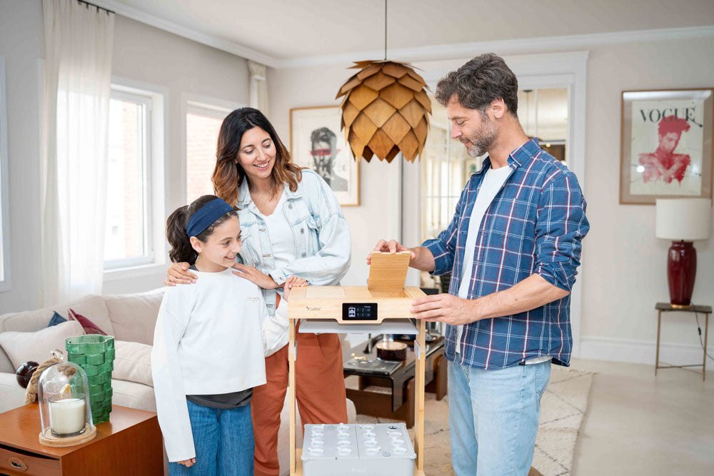 Family beside the LetPot indoor growing system in a kitchen
