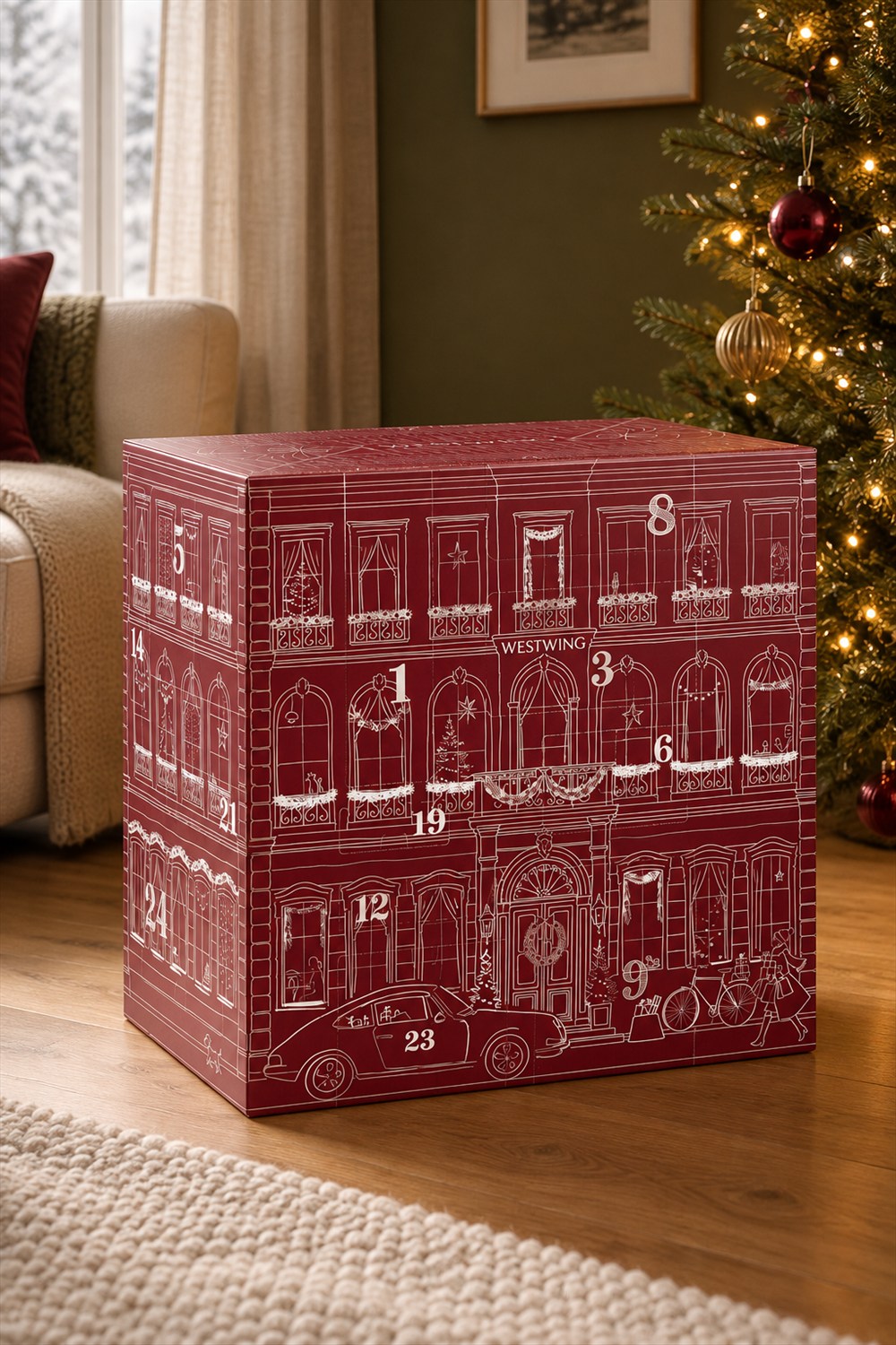 Large burgundy Advent calendar with white townhouse illustrations and numbered doors on an oak floor beside a decorated Christmas tree and cream sofa.