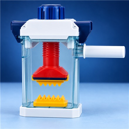 This Hand-Cranked Crushing Toy Lets Kids Squish Objects Inside a Clear Chamber
