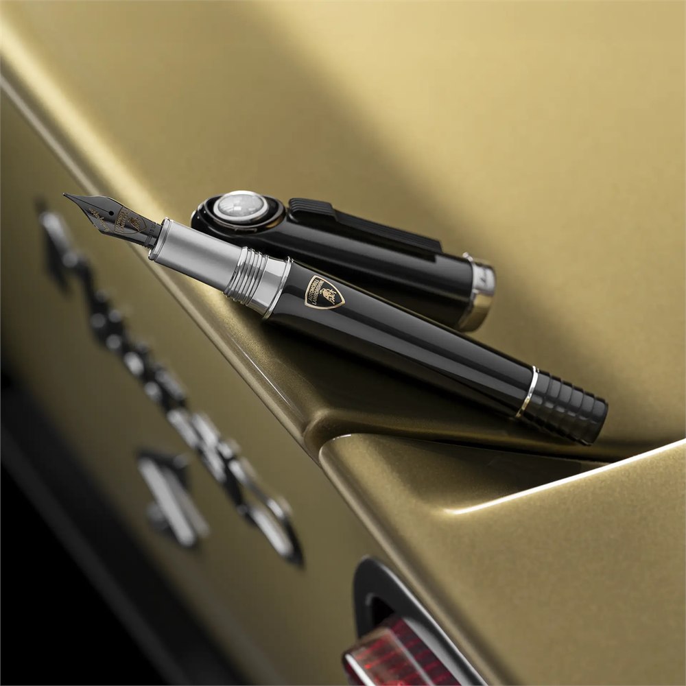 Black fountain pen nib and cap on car bodywork
