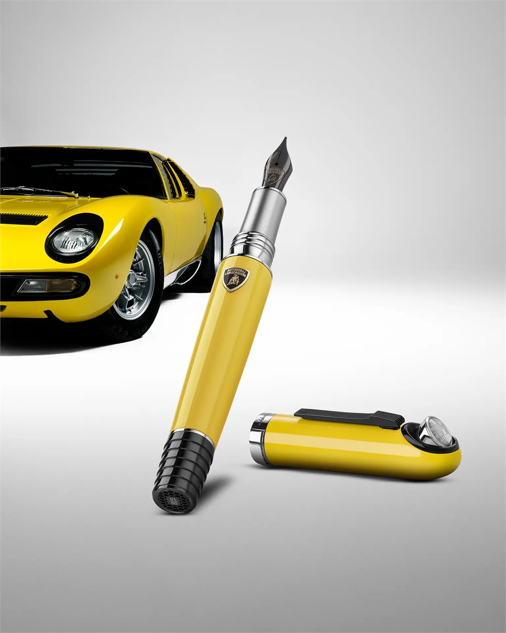 Yellow fountain pen and cap beside a Miura
