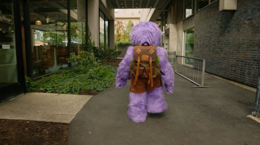 Rear view of Hugo walking with its backpack