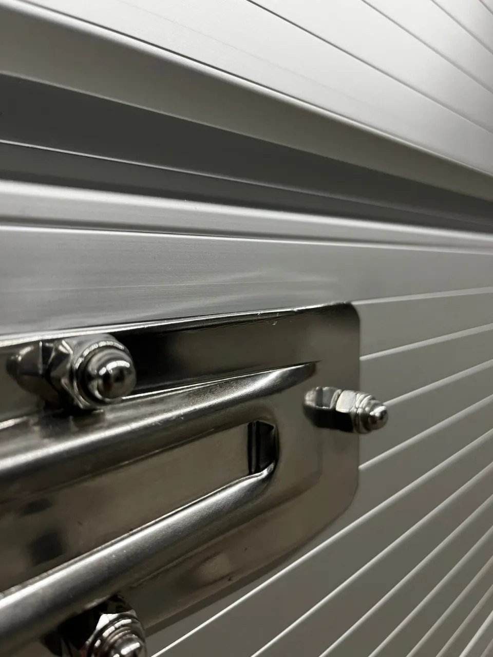 Close view of the trailer door latch and silver body
