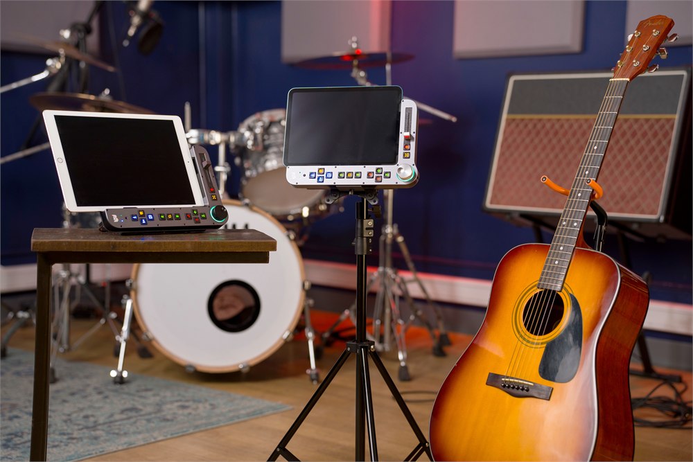 Benjamin controllers on a tabletop and tripod in a music room
