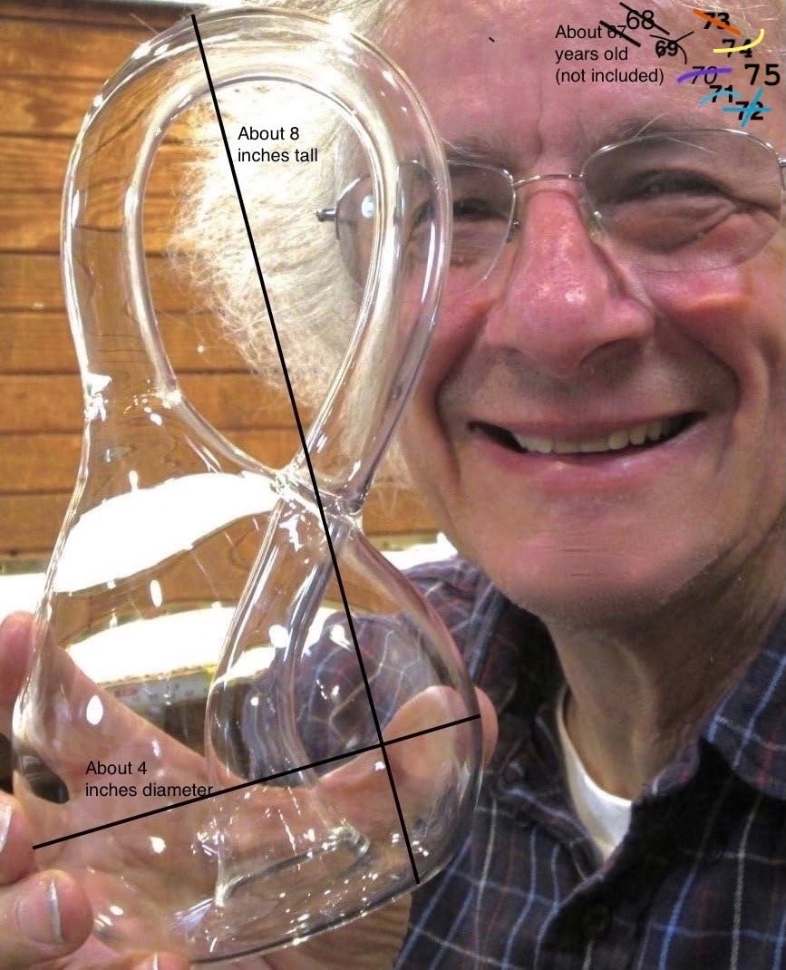 Cliff Stoll holding the glass Klein bottle to show its scale