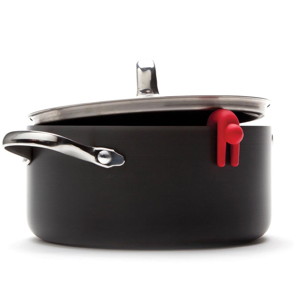 Red Lid Sid figure draped over a black pot rim beneath its lid