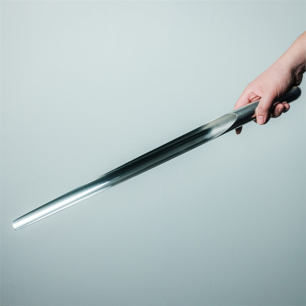 Polished stainless steel shoehorn held outside its stand