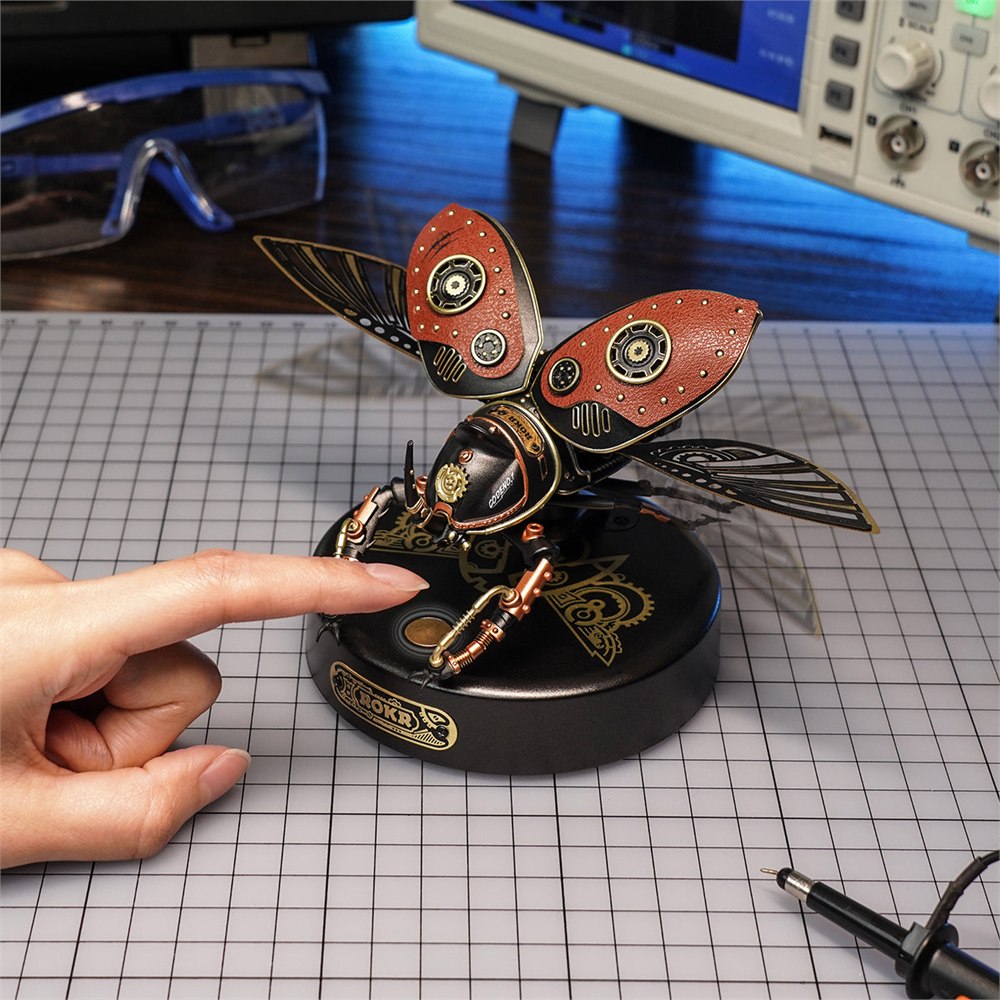 Finger touching the activation control on the beetle display base