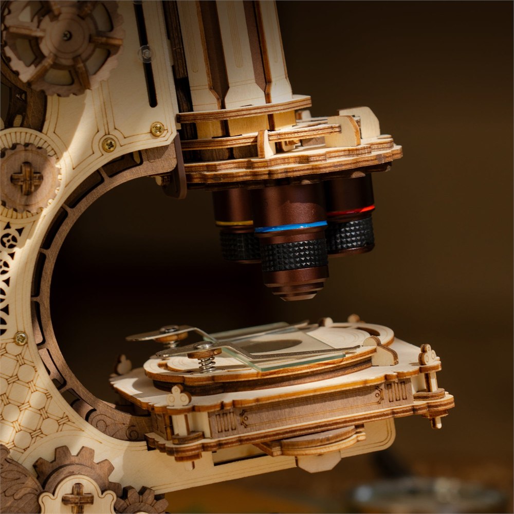 Close view of the wooden microscope stage and lens turret