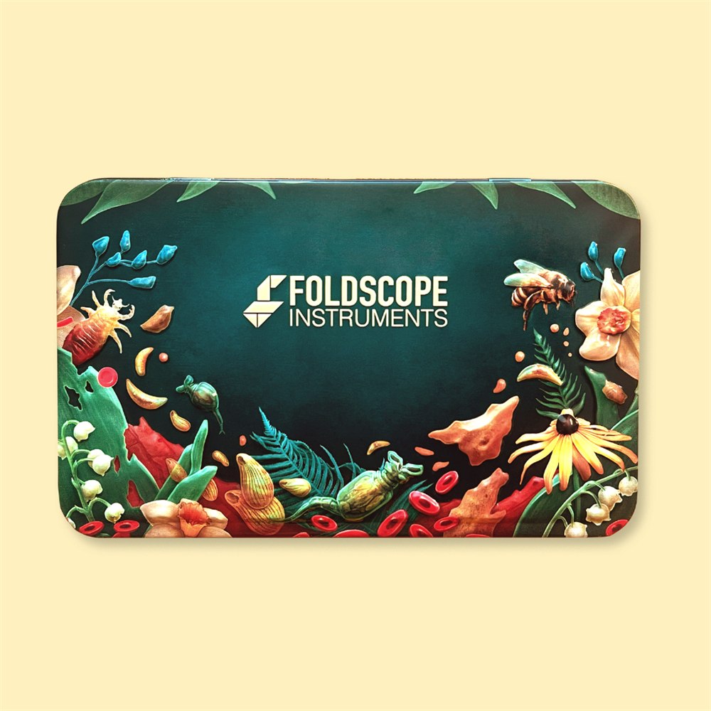 Decorated metal storage case included with the Foldscope Explorer Kit