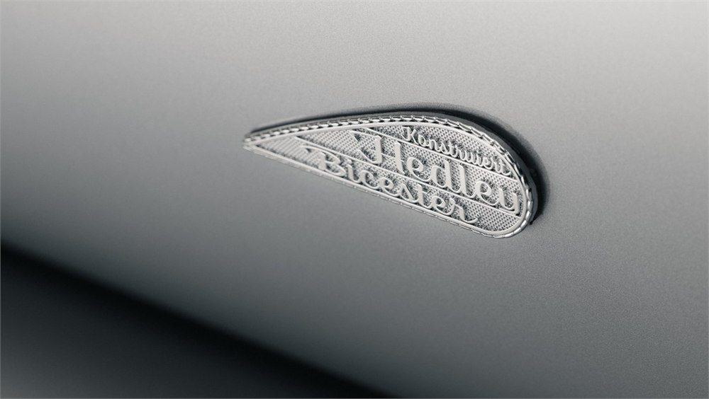 Close view of the Hedley Studios coachbuilder badge on the silver body