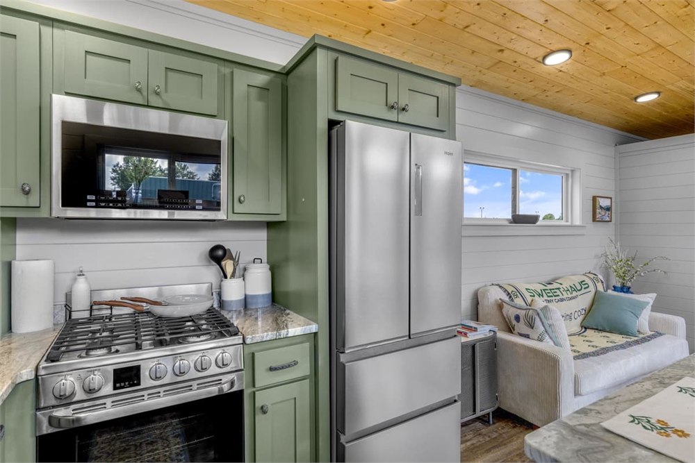 Nordic Nook kitchen with green cabinetry and stainless appliances