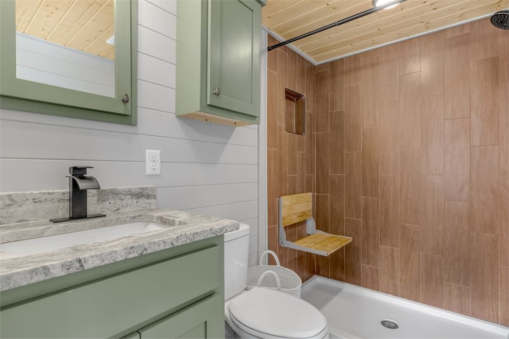 Nordic Nook bathroom with vanity, shower, and toilet