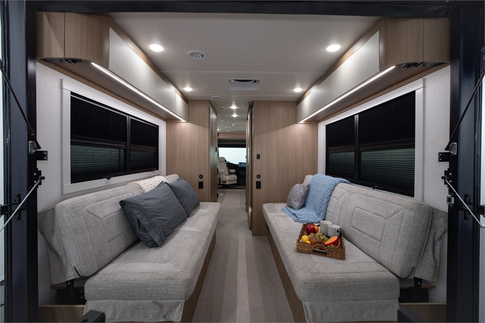 Facing lounge seats and central aisle inside the Origin