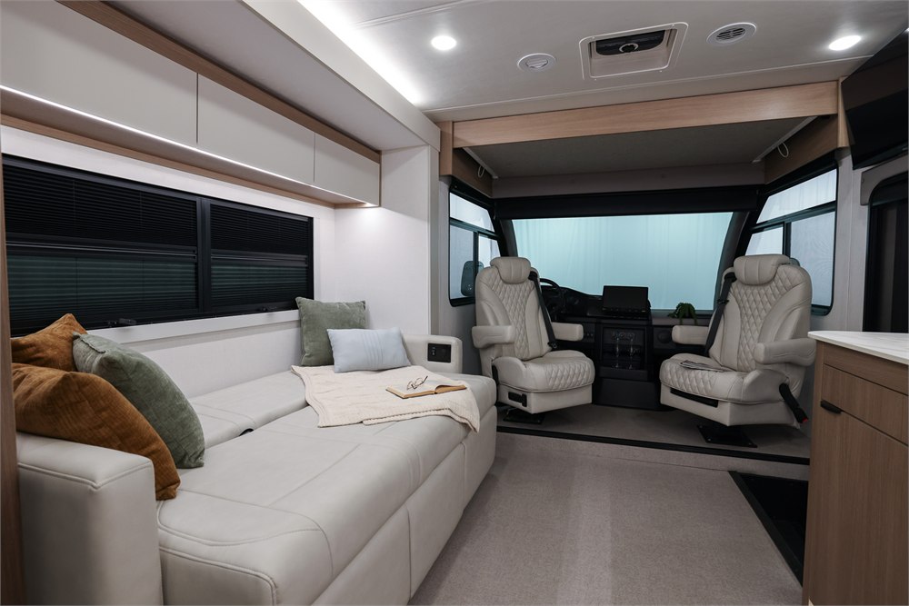 Origin cockpit with quilted captain chairs and overhead bed area