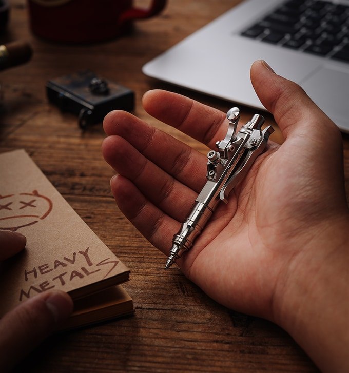 Compact Gennai SL01 mechanical pen resting in an open hand for scale