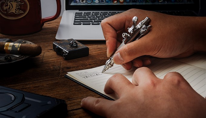 Gennai SL01 ballpoint pen being used to write in a notebook