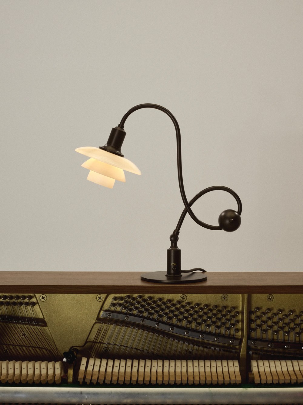 PH 1/1 Piano Table Lamp positioned above exposed piano strings