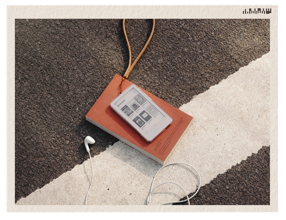 Picco e-reader resting on a notebook with a lanyard