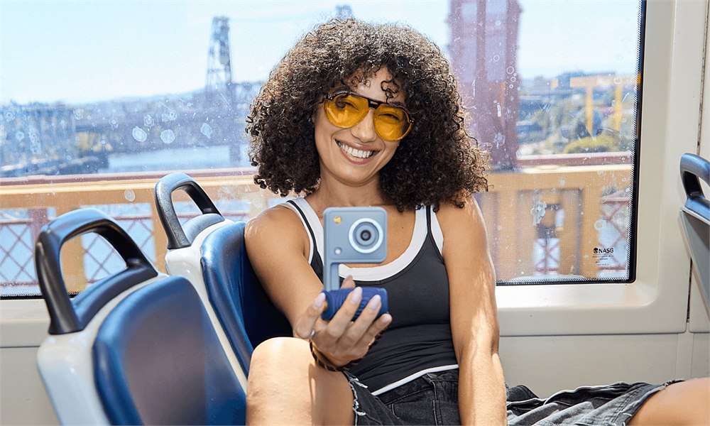 Woman holding the Portal camera while traveling