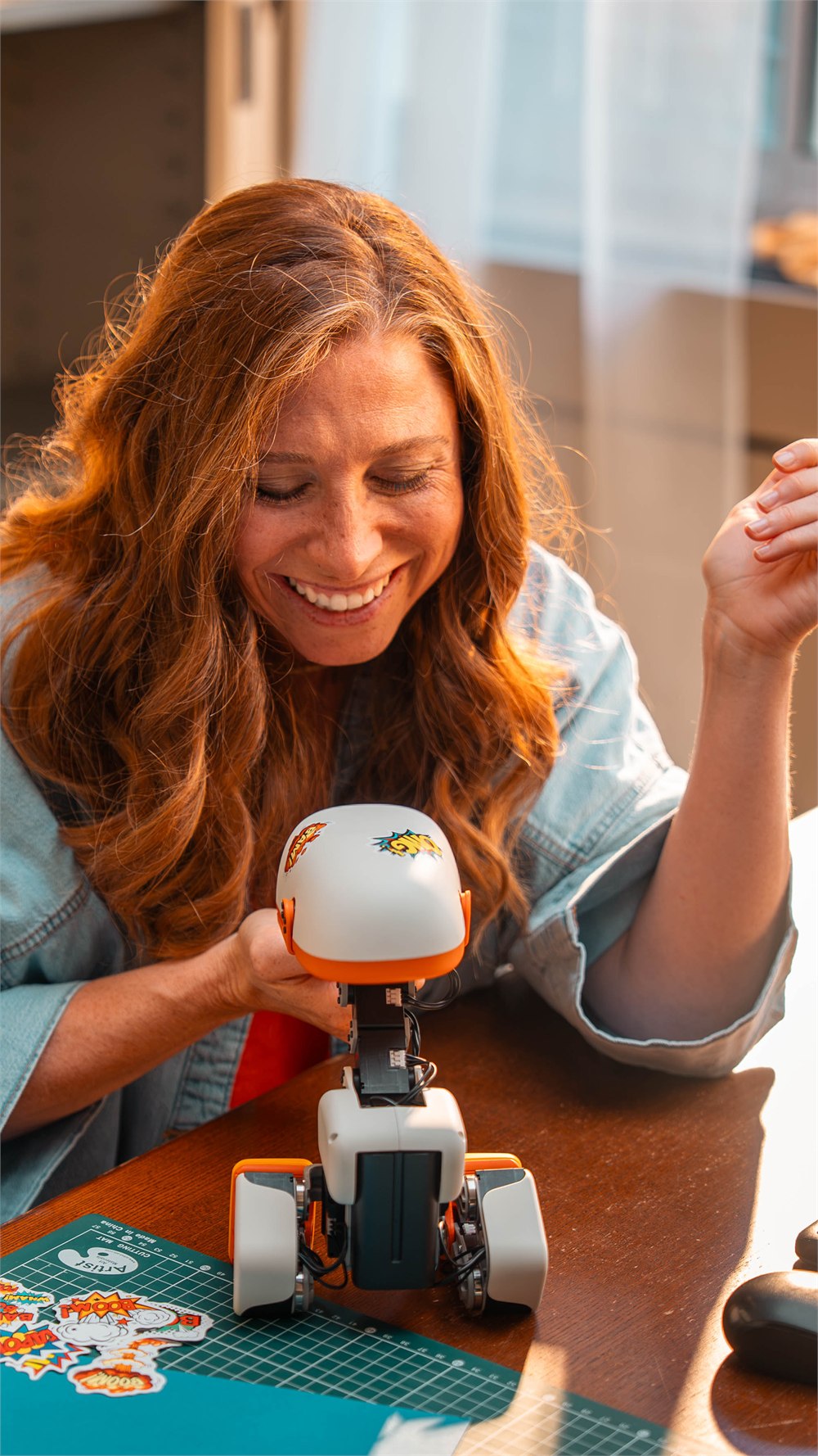 Microduck robot being played with at a table