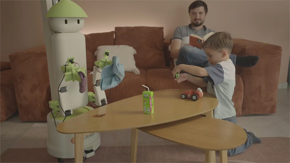 Flourish household robot beside a coffee table and sofa