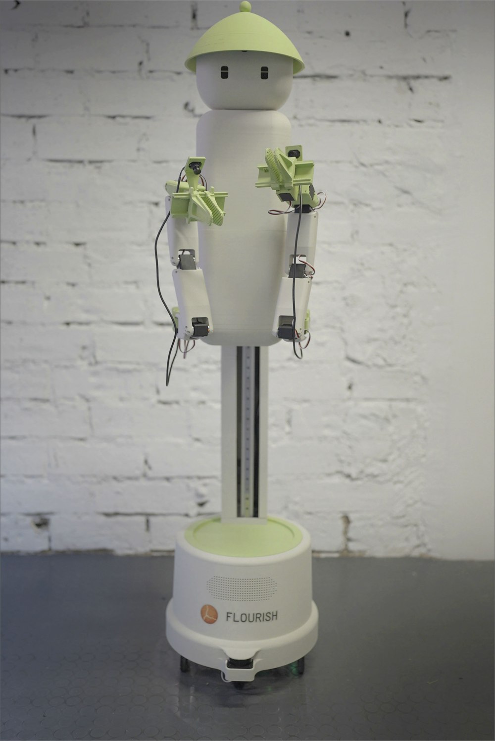 Full view of Flourish 1 with articulated arms and round wheeled base