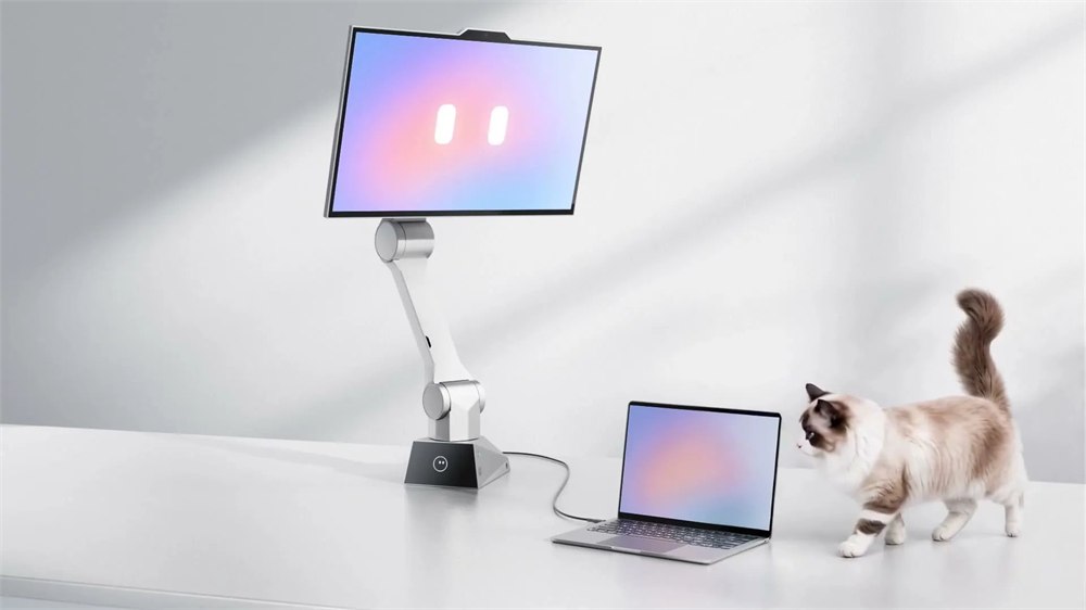 CyboPal robotic monitor above a desk beside a laptop
