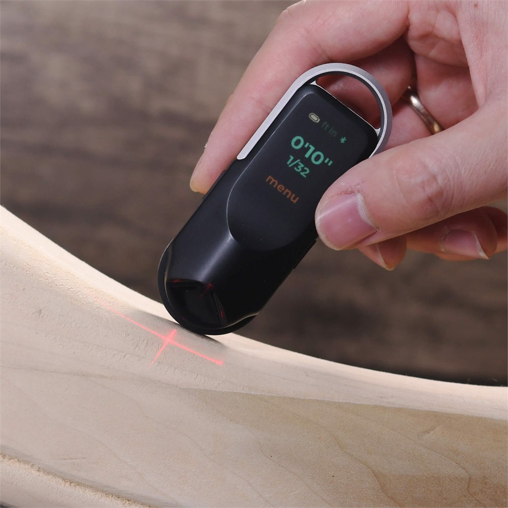 NeoRulerGO rolling along a curved wooden edge