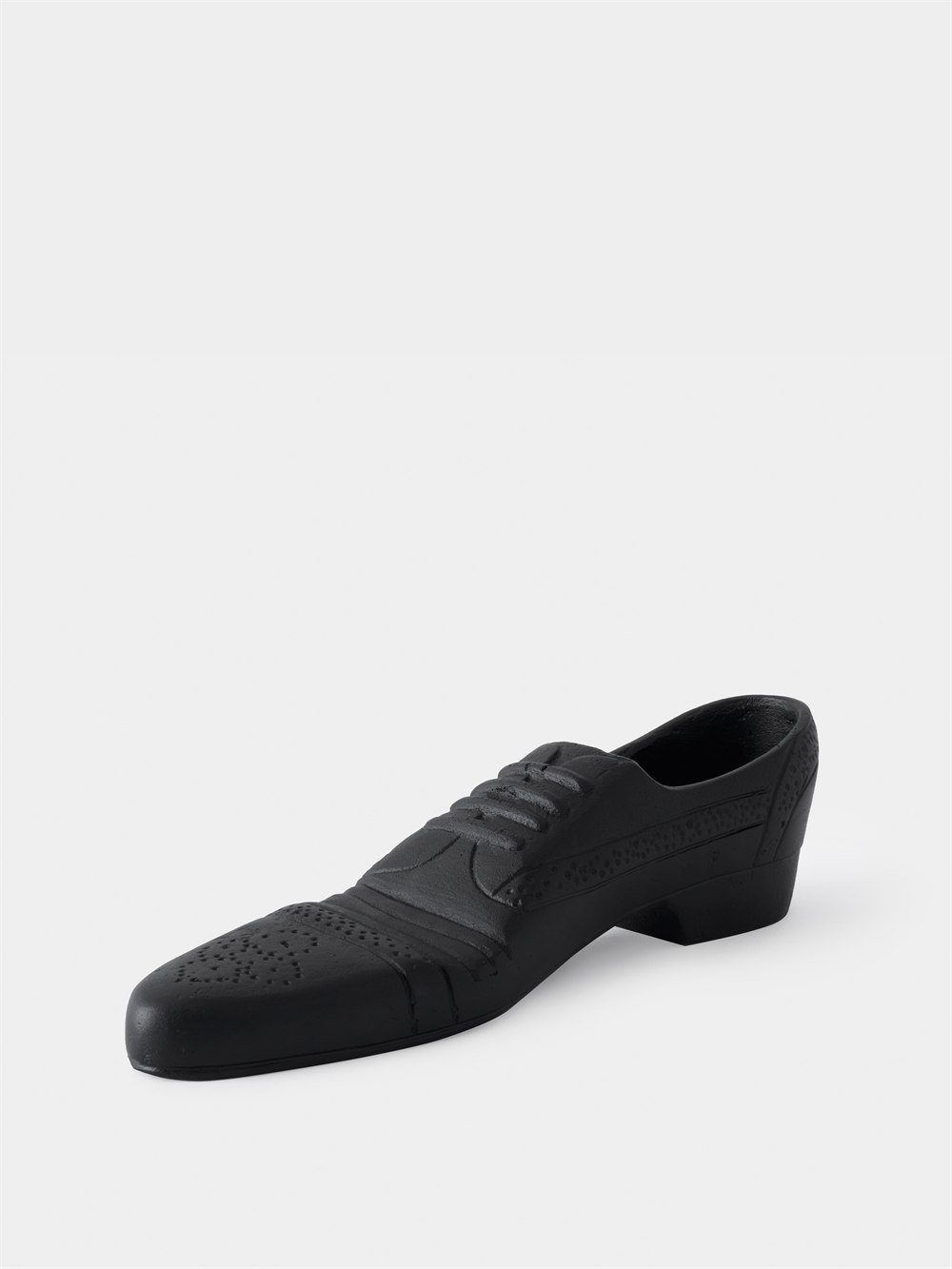 Three-quarter view of the black cast iron shoe doorstop