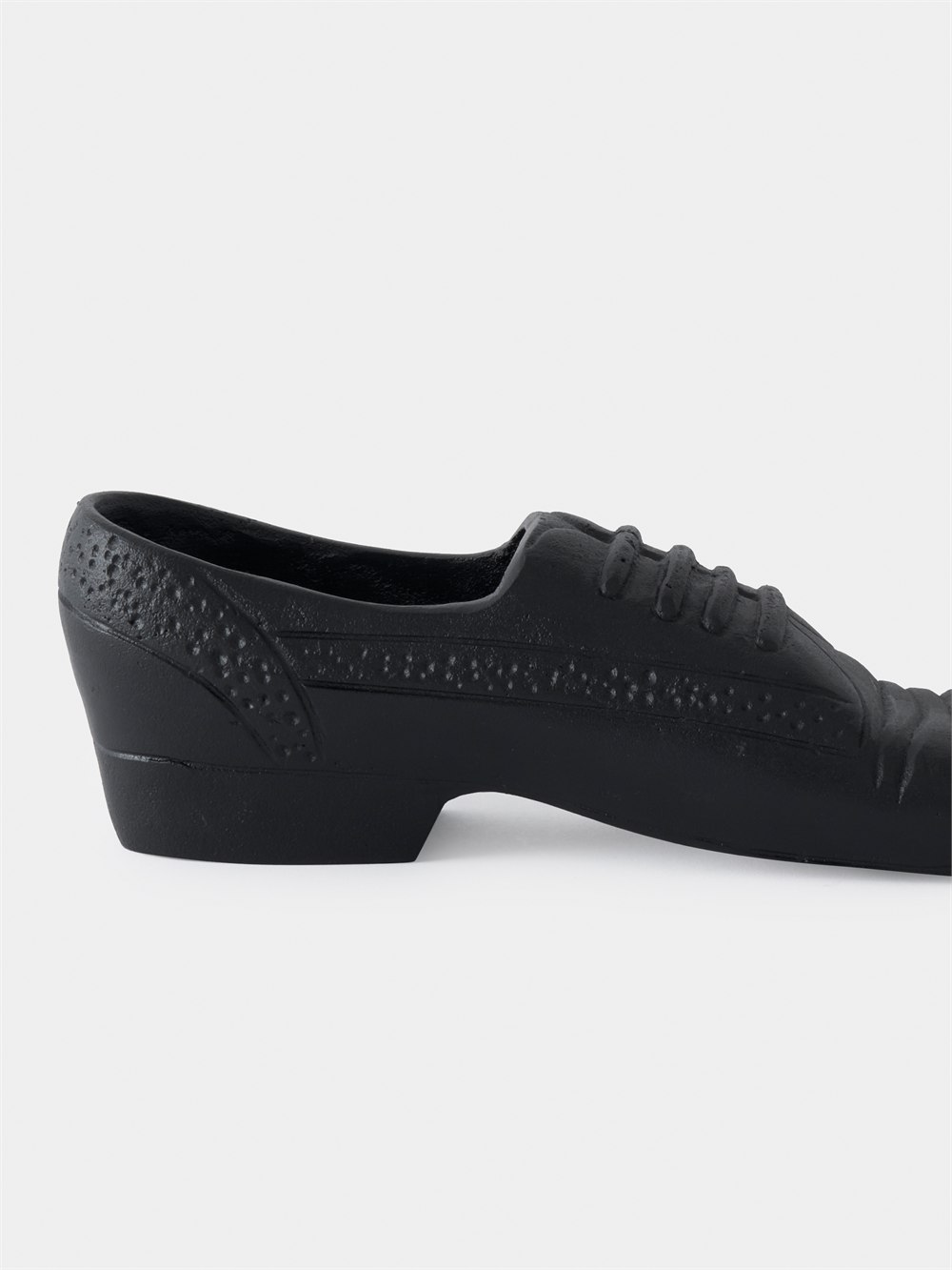 Side profile of the black shoe doorstop