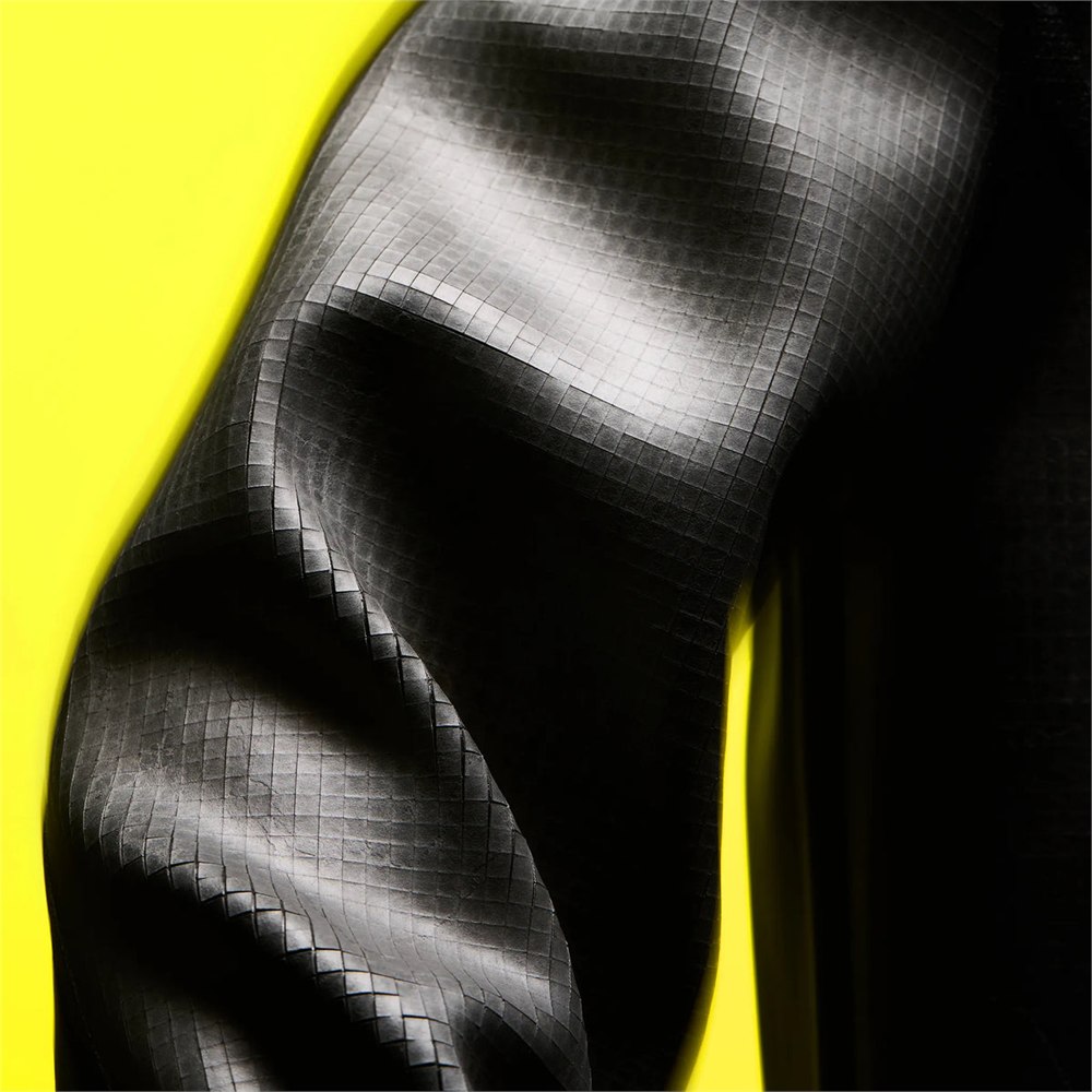 Close view of a bent sleeve showing the grid of small slate tiles