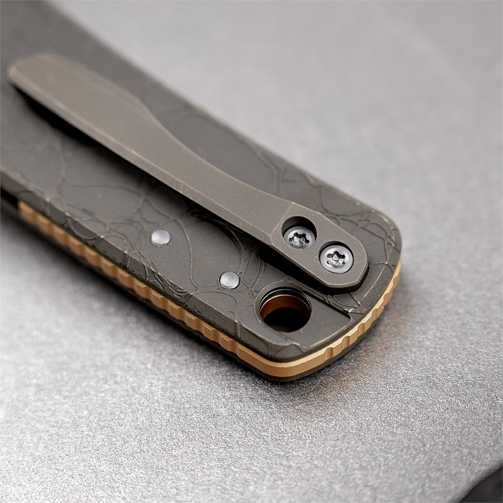 Close-up of the titanium pocket clip and recessed lanyard hole