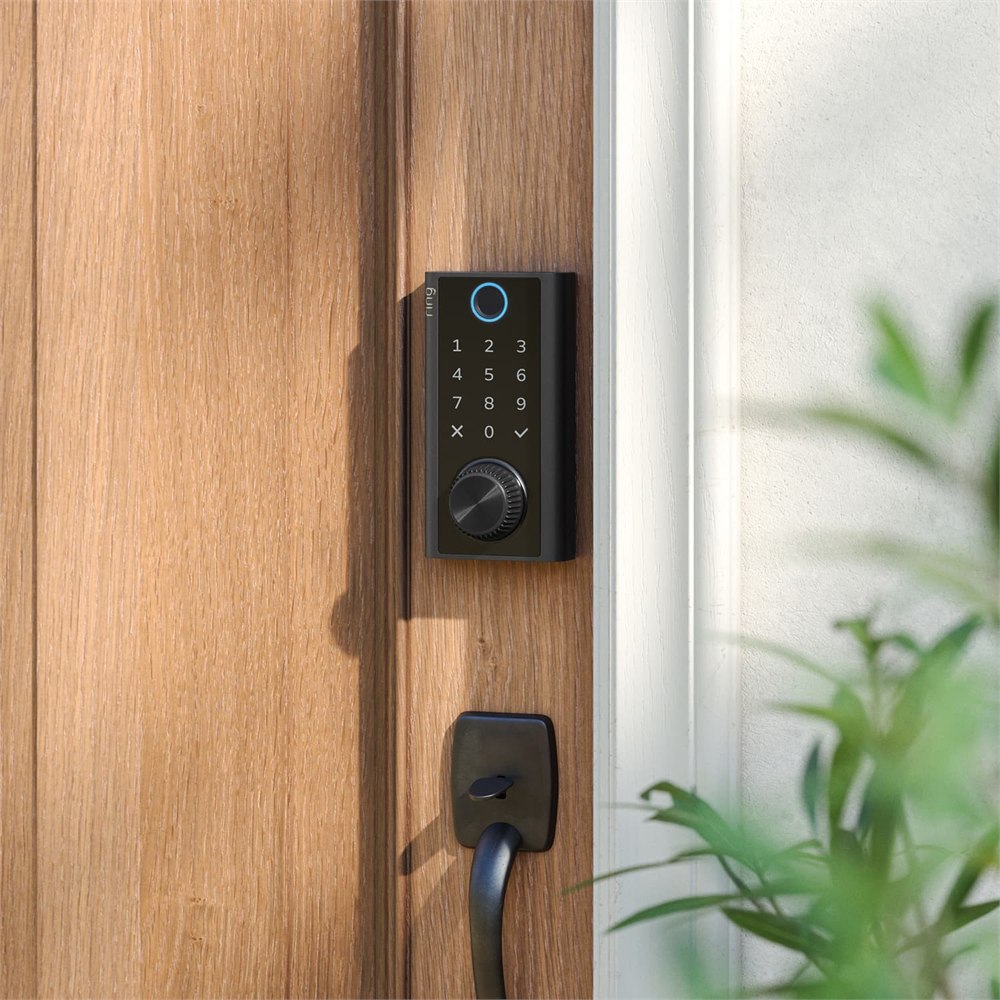 Black smart lock mounted above a door handle