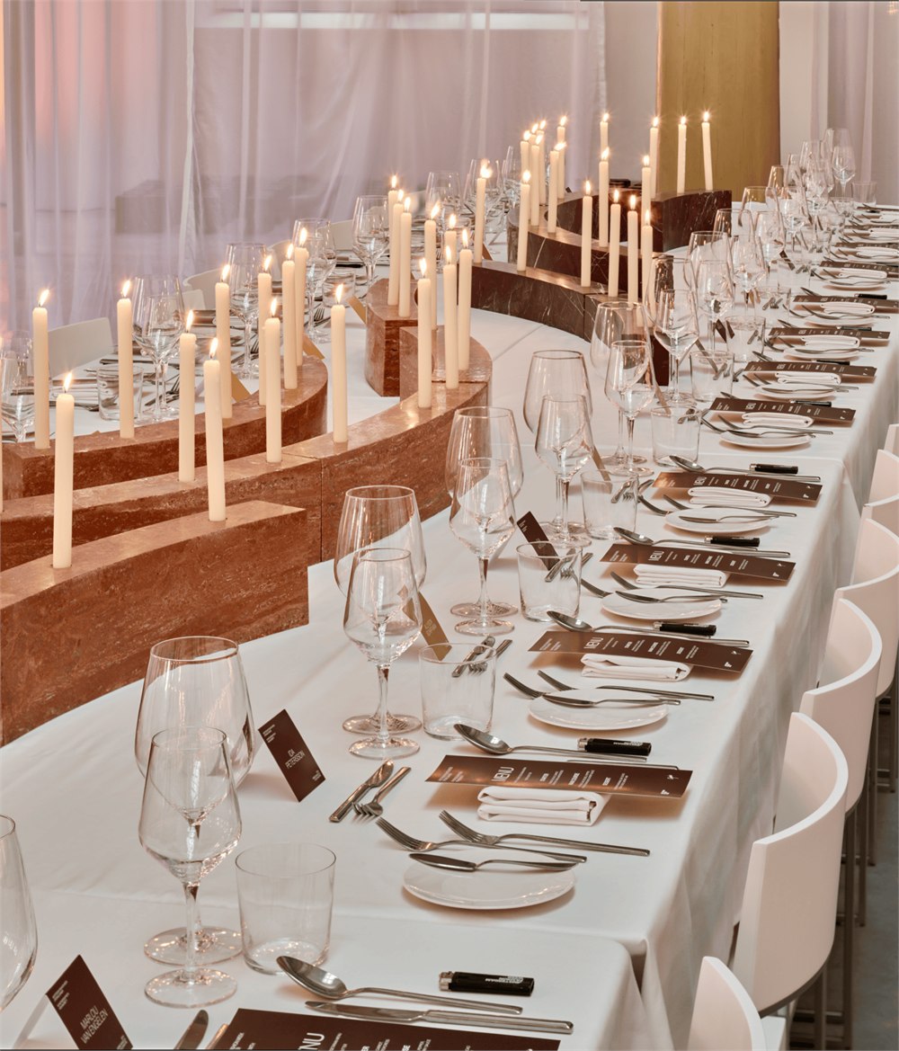 Original stone candleholder banquet installation viewed along the table