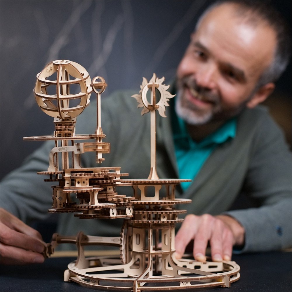 Builder operating the wooden astronomy model